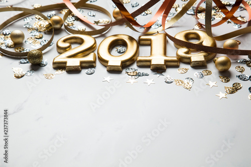 Happy new year 2019 gold background with confetti on a merble background © ink drop