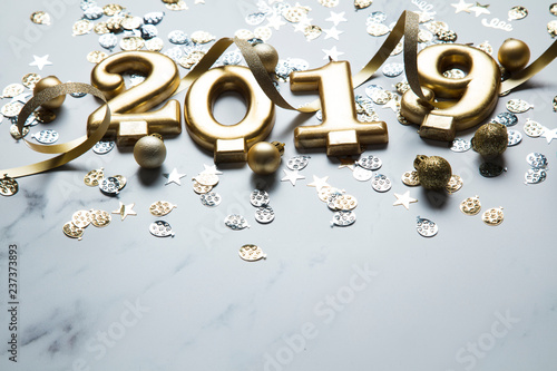 Happy new year 2019 gold background with confetti on a merble background photo