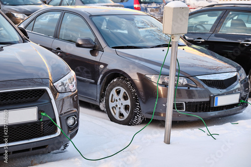 The cars on the parking is connected to electricity for heating in the winter in Finland © Lev Karavanov