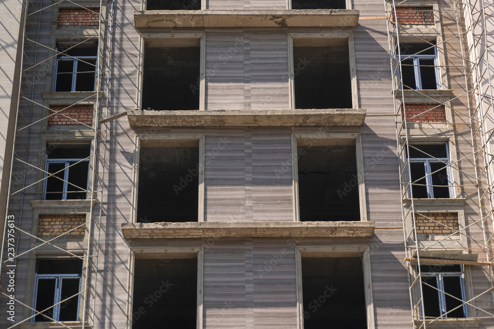 marble finishing works on the facade of a high building