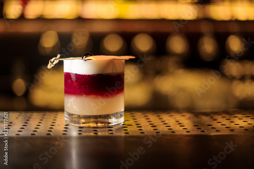 Glass of a New York sour cocktail on the steel wooden bar counter photo