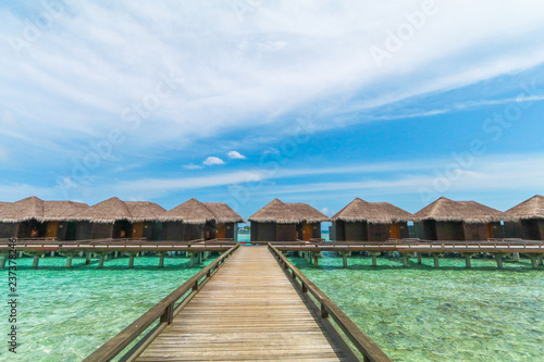 Fototapeta Naklejka Na Ścianę i Meble -  Amazing island in the Maldives ,water villa ,wooden bridge and  beautiful  turquoise waters with  blue sky  background for holiday vacation .