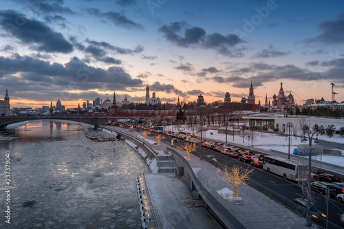 view of Moscow Kremlin and Moscow river with street illumination at sunset