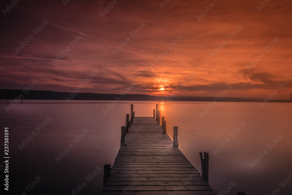 Fototapeta old wooden pier at sunset