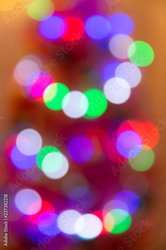 Bright bokeh on the background of Christmas trees and garlands background New Year 2019 year