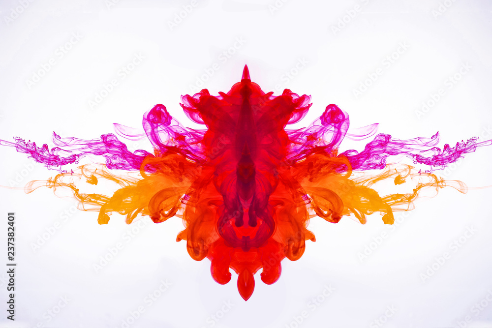 Ink flowing in liquid. Mixing paint under water. Curved smoke was photographed in motion. The drops of acrylic ink flowing in water isolated on white background. Abstract pattern.