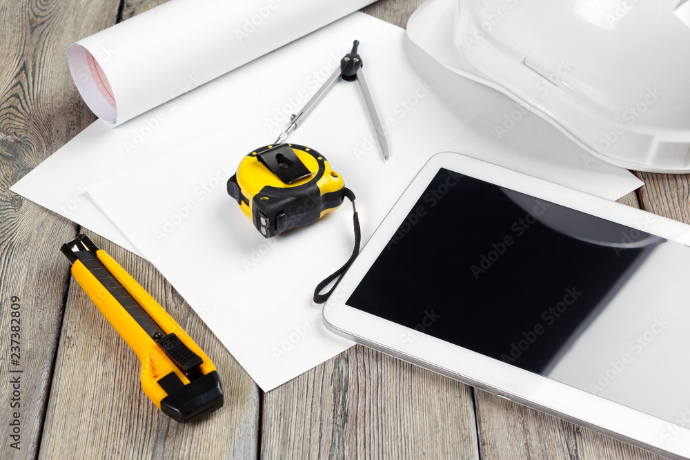 Fototapeta premium top view of architect workplace with blueprint paper and digital tablet with blank screen