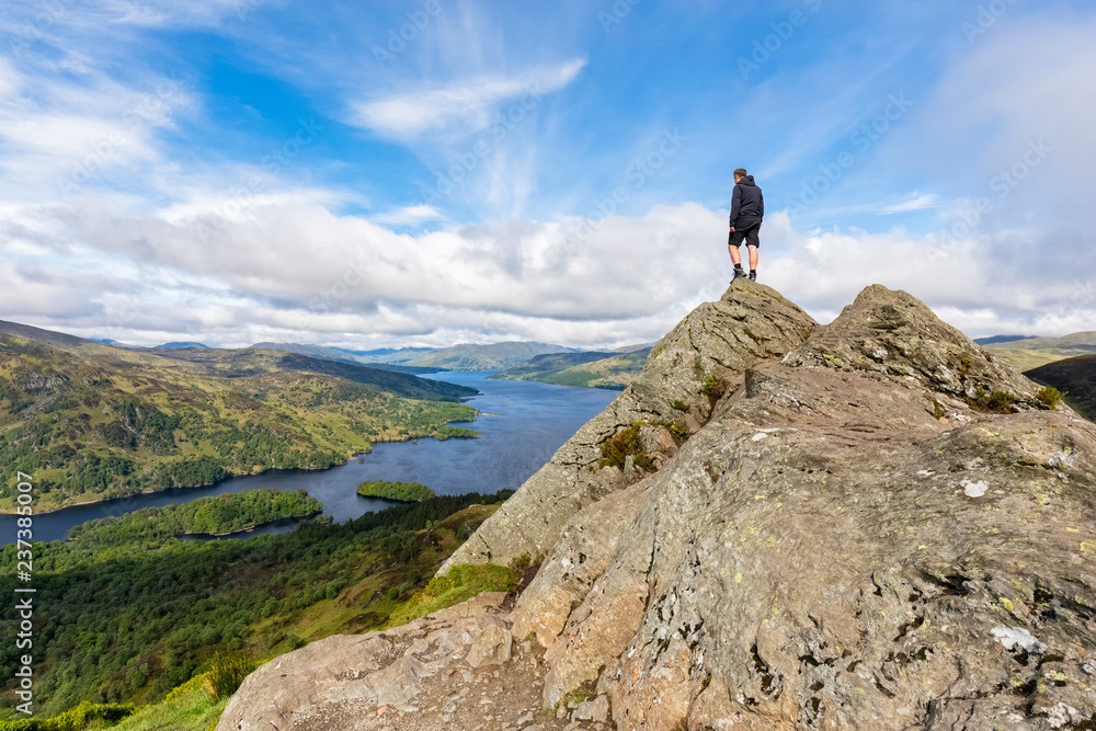 UK, Scotland, Highland, Trossachs, tourist looking from mountain Ben A'an to Loch Katrine
