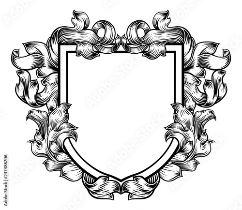 A coat of arms crest heraldic medieval knight or royal family shield. Vintage motif with filigree leaf heraldry. photo