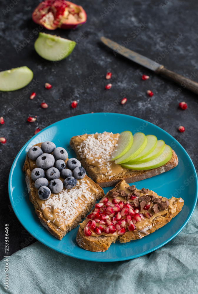 Bread slices with various toppings on plate Bread slices with various toppings on plate