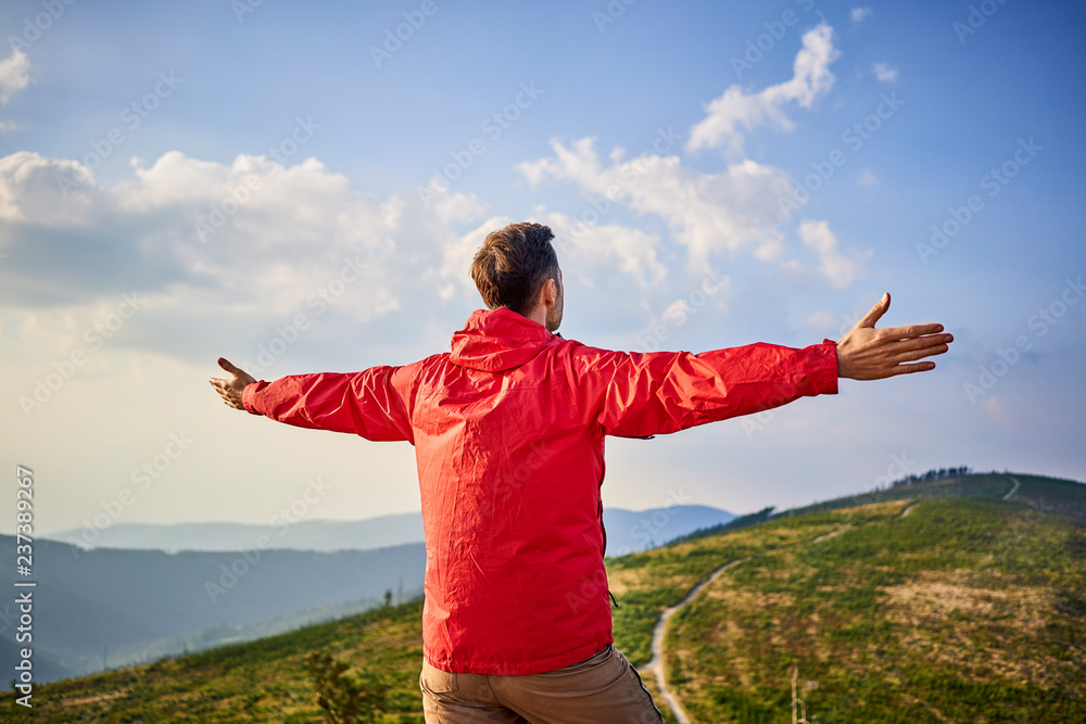Rear view of hiker in mountains enjoying the view Rear view of hiker in mountains enjoying the view