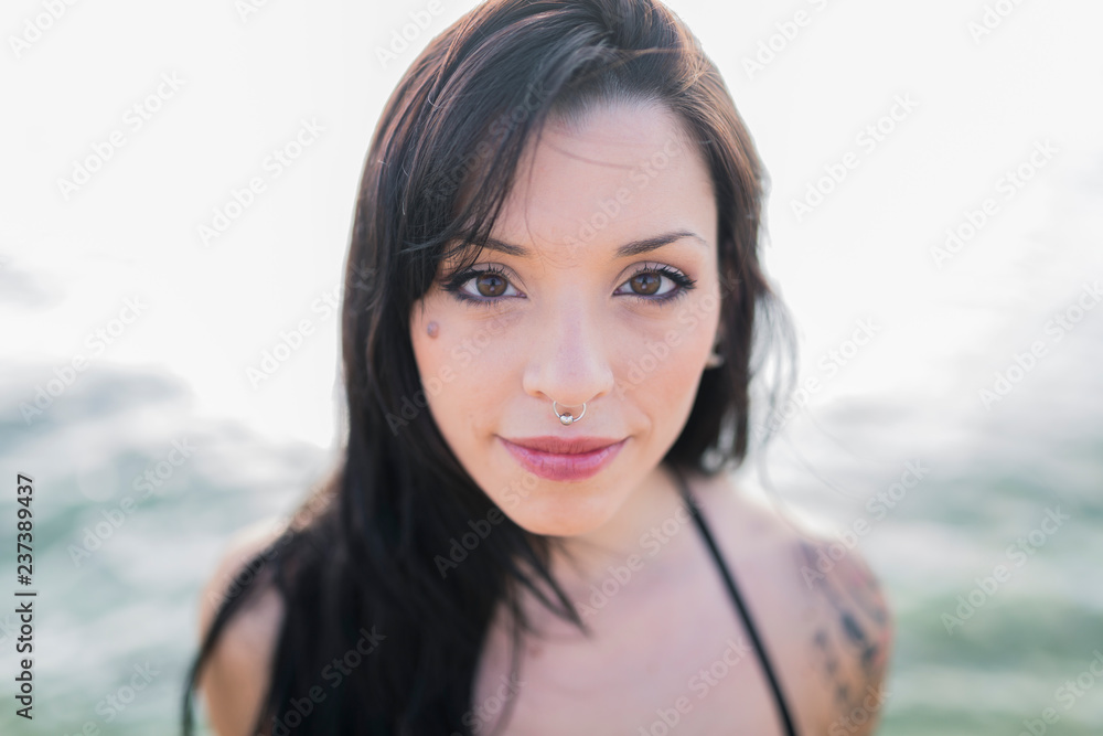 Portrait of smiling young woman with nose piercing at the sea Portrait of smiling young woman with nose piercing at the sea