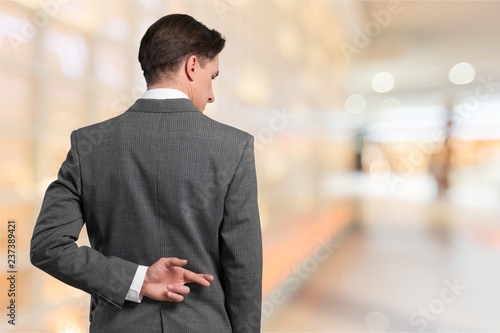 Photos Businessman with his fingers crossed behind his back - concept