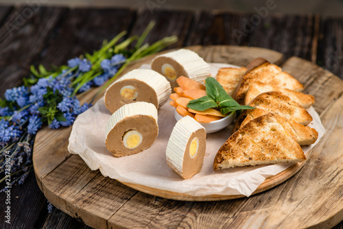 quail egg pate on a wooden board photo