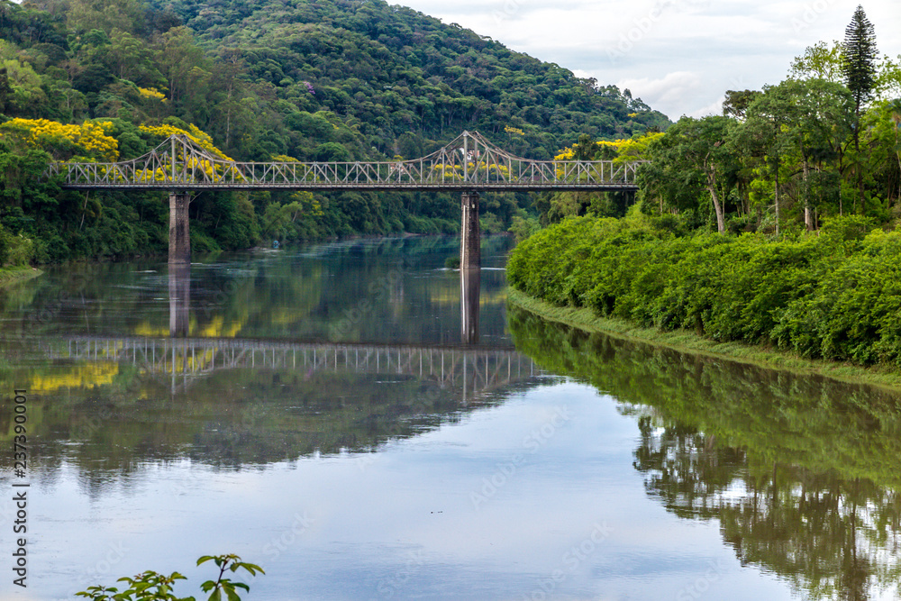 Old iron bridge and granite pillars on the Itajai-Açu river in Blumenal, Santa Catarina