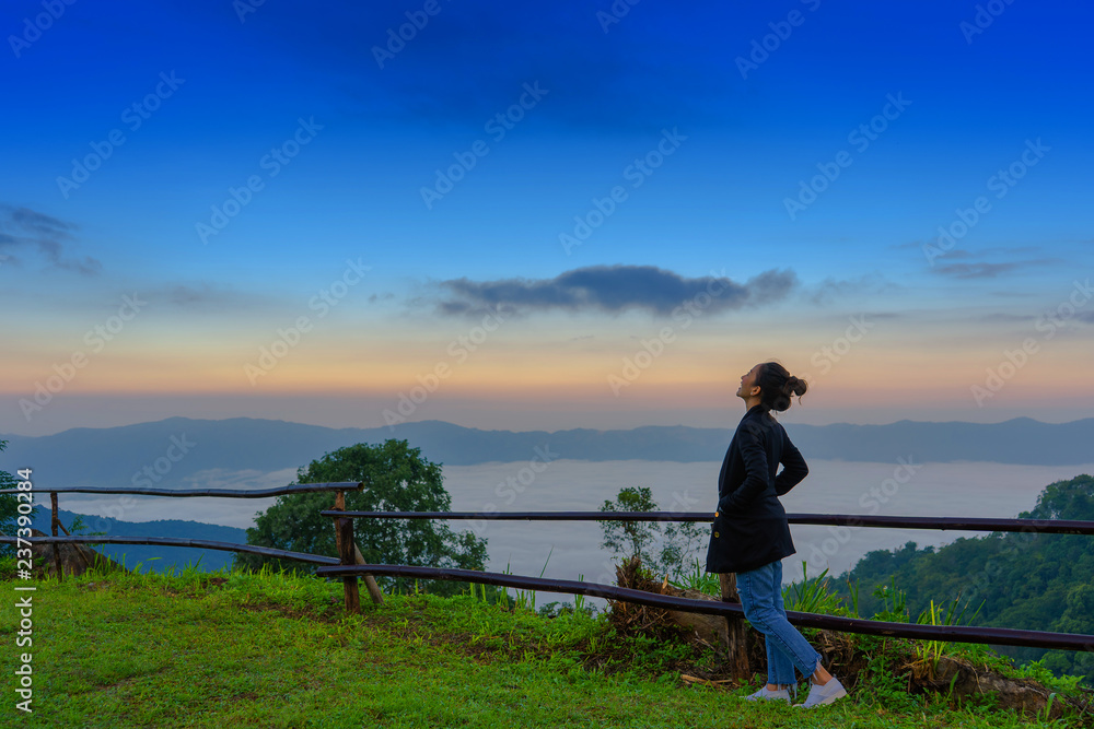 traveler girl relaxing in good morning time in Mist on Phu Chi Fa in chiang rai province