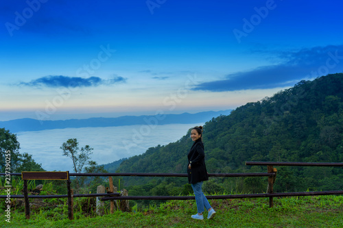 traveler girl relaxing in good morning time in Mist on Phu Chi Fa in chiang rai province © etemwanich