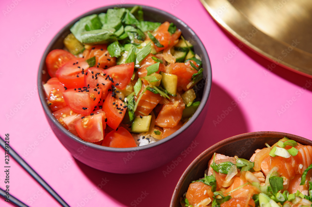 Poke bowl with marinated salmon and vegetable salad on rice