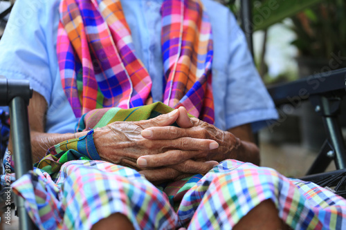 Hands of senior man sitting on bench in home