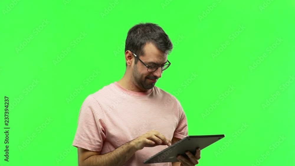 man using a tablet on green screen chroma key background man using a tablet on green screen chroma key background