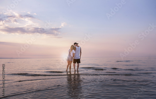 one young beautiful couple in love admire the sea view