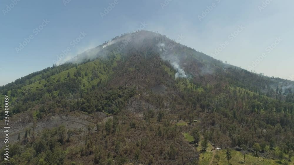 aerial view forest fire smoke on slopes hills. wild fire in tropical forest, Java Indonesia. natural disaster fire in Southeast Asia aerial view forest fire smoke on slopes hills. wild fire in tropical forest, Java Indonesia. natural disaster fire in Southeast Asia