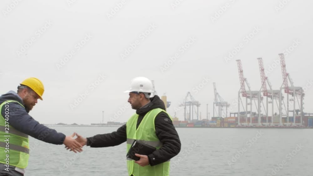 port workers in helmets are welcomed. sea port port workers in helmets are welcomed. sea port