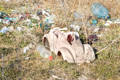 Fototapeta Naklejka Na Ścianę i Meble -  child toy on spontaneous waste dump, environmental pollution heritage