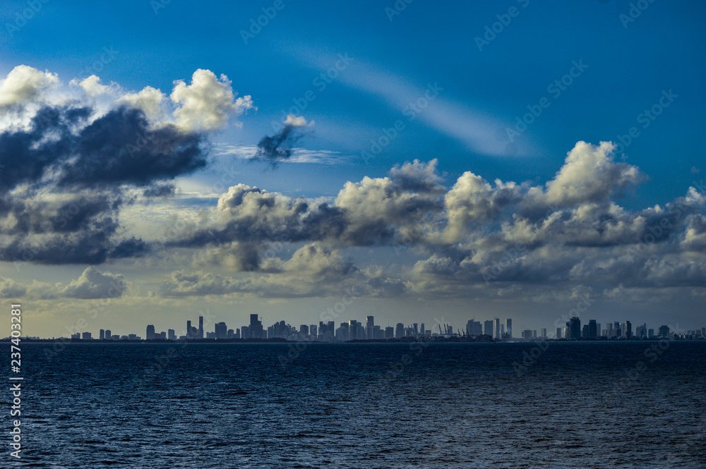 Miami FL USA skyline with dramatic puffy clouds as seen from deck of ship 