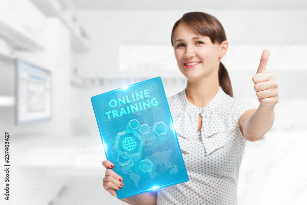 The concept of business, technology, the Internet and the network. A young entrepreneur working on a virtual screen of the future and sees the inscription: Online training The concept of business, technology, the Internet and the network. A young entrepreneur working on a virtual screen of the future and sees the inscription: Online training