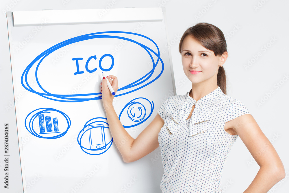 Business, Technology, Internet and network concept. A young entrepreneur writes on the blackboard the word: ICO Business, Technology, Internet and network concept. A young entrepreneur writes on the blackboard the word: ICO