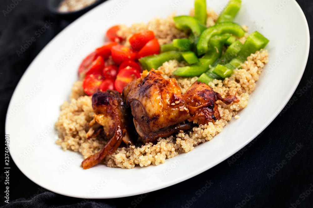 quinoa with chicken and vegetables on white plate