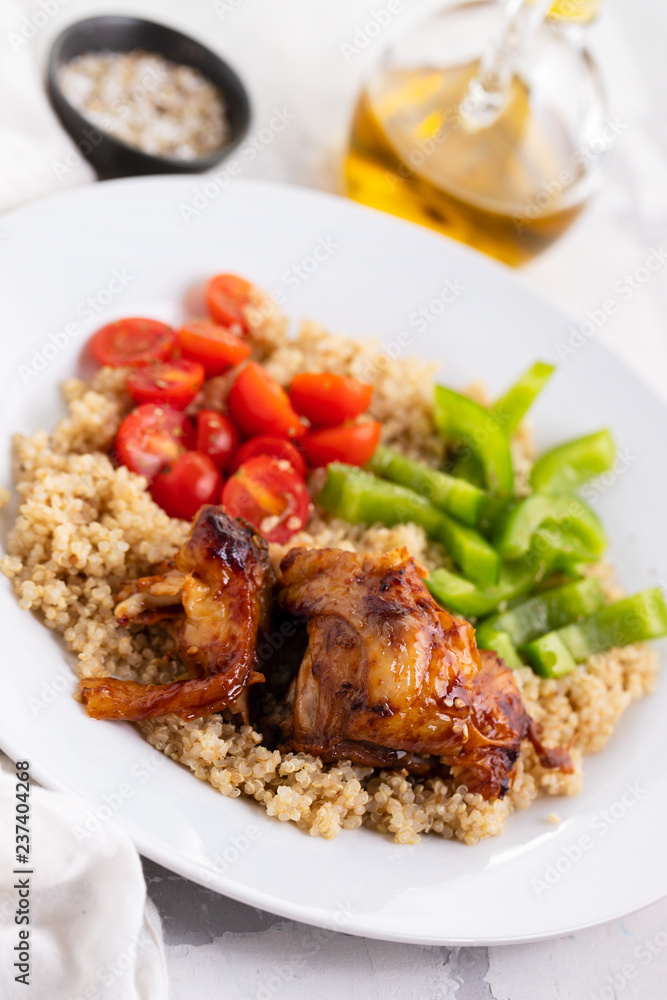 quinoa with chicken and vegetables on white plate