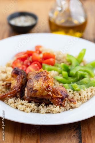 quinoa with chicken and vegetables on white plate