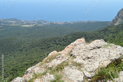 THE VIEW FROM THE ROCKY TOP OF THE MOUNTAIN TO THE PINE FOREST AND THE SEASIDE TOWN photo