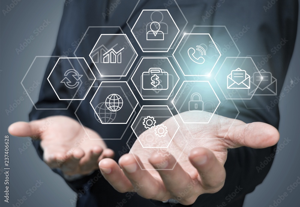 Man touching business elements icons on screen Man touching business elements icons on screen