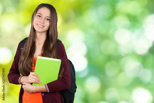 Young Student Girl with backpack and books photo