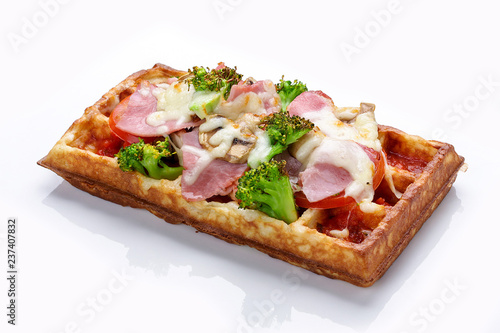 Belgian waffle on a white background. Stuffed with ham cheese and broccoli