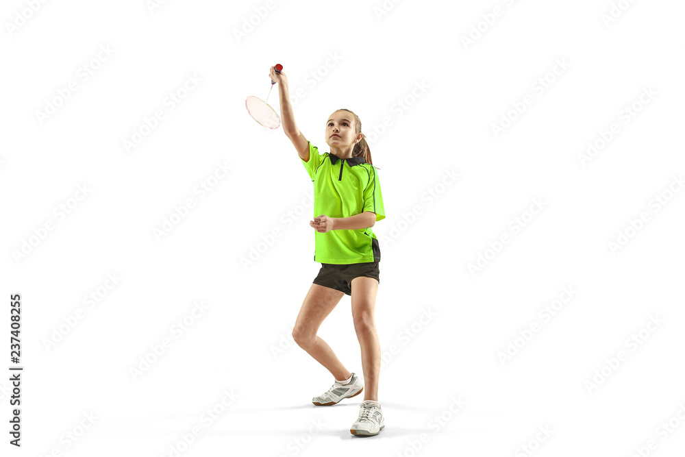 The one caucasian young teenager girl playing badminton at studio. The female teen player isolated on white background in motion The one caucasian young teenager girl playing badminton at studio. The female teen player isolated on white background in motion
