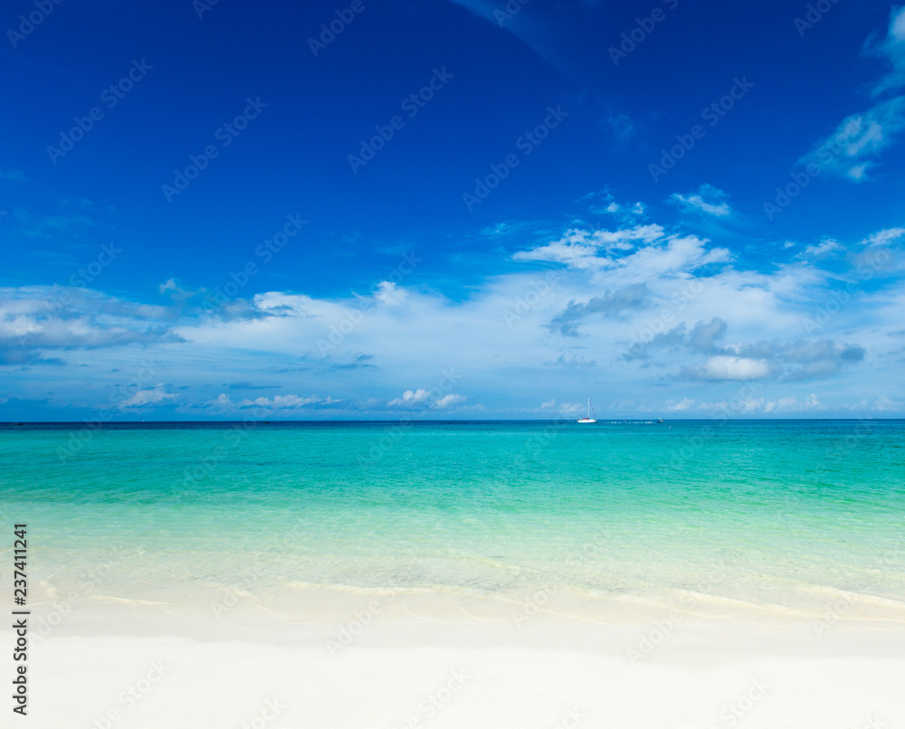 tropical beach in Maldives with few palm trees and blue lagoon