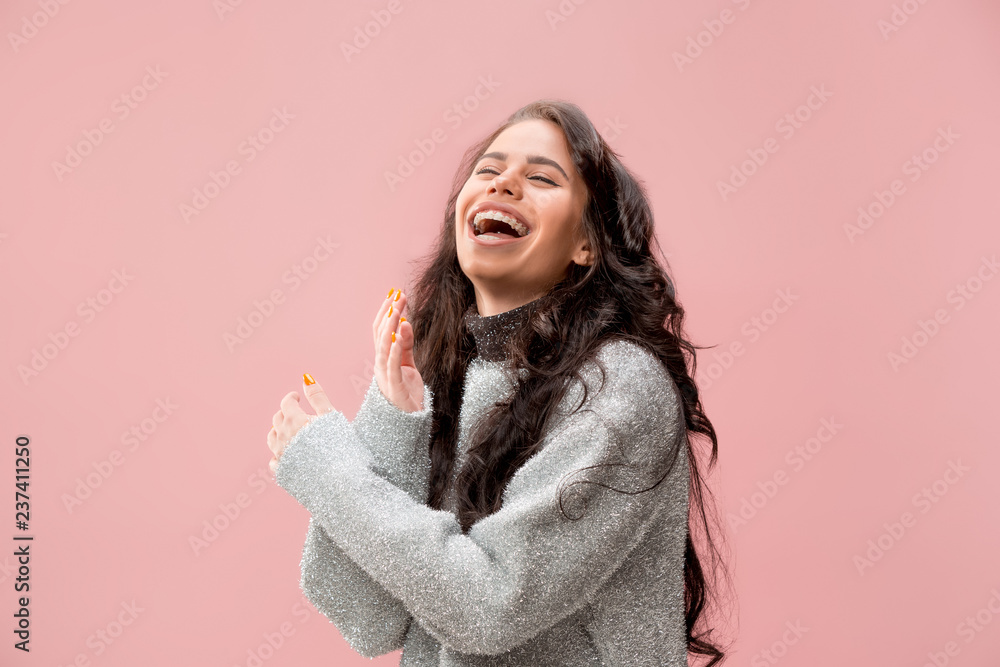 Happy business woman standing and smiling isolated on pink studio background. Beautiful female half-length portrait. Young emotional woman. The human emotions, facial expression concept. Happy business woman standing and smiling isolated on pink studio background. Beautiful female half-length portrait. Young emotional woman. The human emotions, facial expression concept.