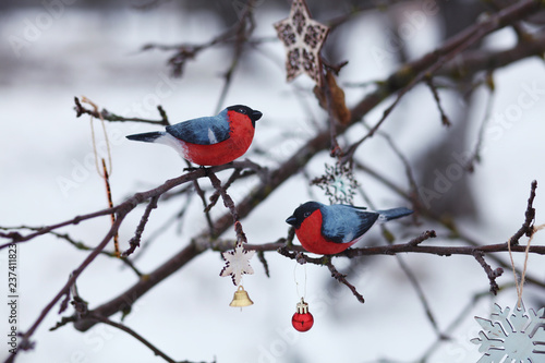 wooden bullfinches on the tree branch/new year and christmas background