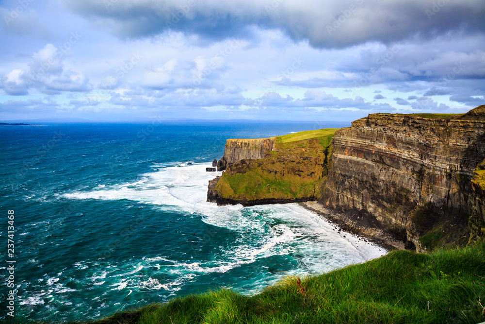 Cliffs of Moher, Burren, County Clare, Ireland. Sea cliffs rise above Atlantic Ocean. View from top cliffs in Galway Bay. Popular tourist attraction. Scenic seascape. Irish rural countryside nature.