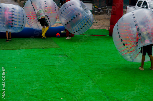 young people playing bumperball outdoors photo