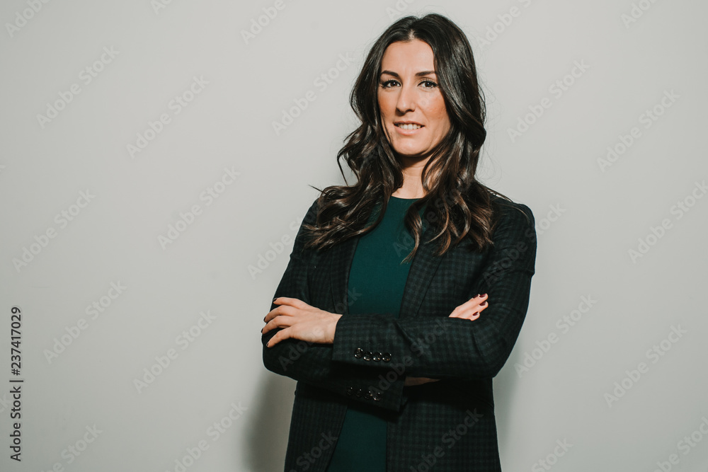 Beautiful, young and successful business woman on gray background with copy space. Confident young manager. Lifestyle. Beautiful, young and successful business woman on gray background with copy space. Confident young manager. Lifestyle.