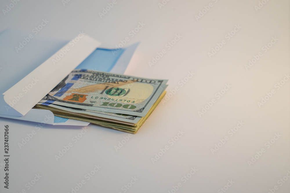 US $ Dollar banknotes in envelope on white background US $ Dollar banknotes in envelope on white background