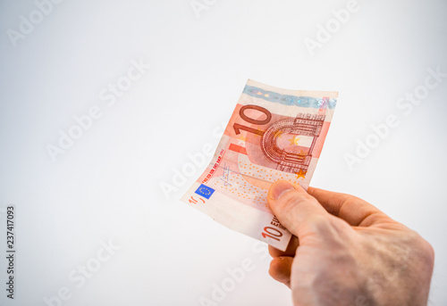 €10 Ten Euro banknote being offered by hand