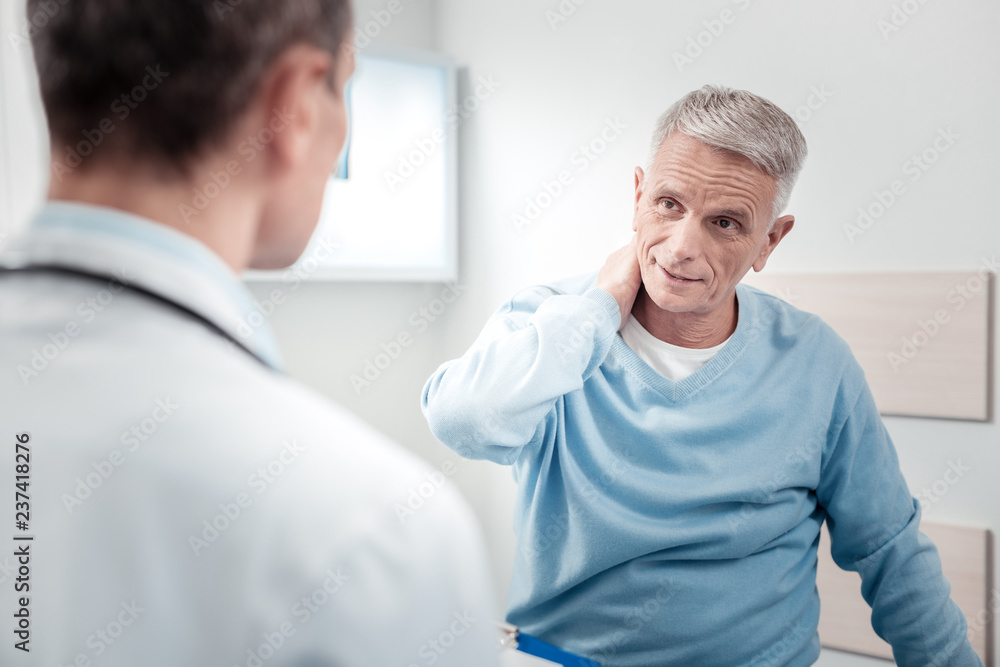 Fototapeta premium Delighted mature man touching his neck