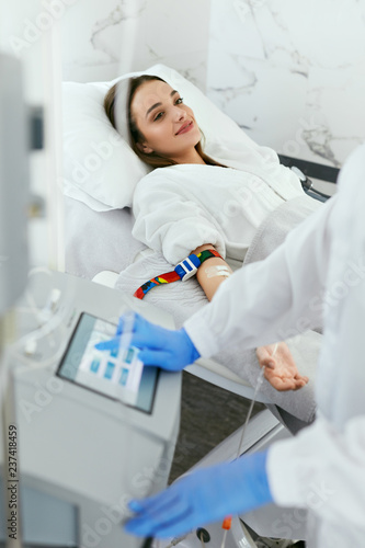 Photos Blood Ozone Therapy. Woman At Blood Transfusion Treatment