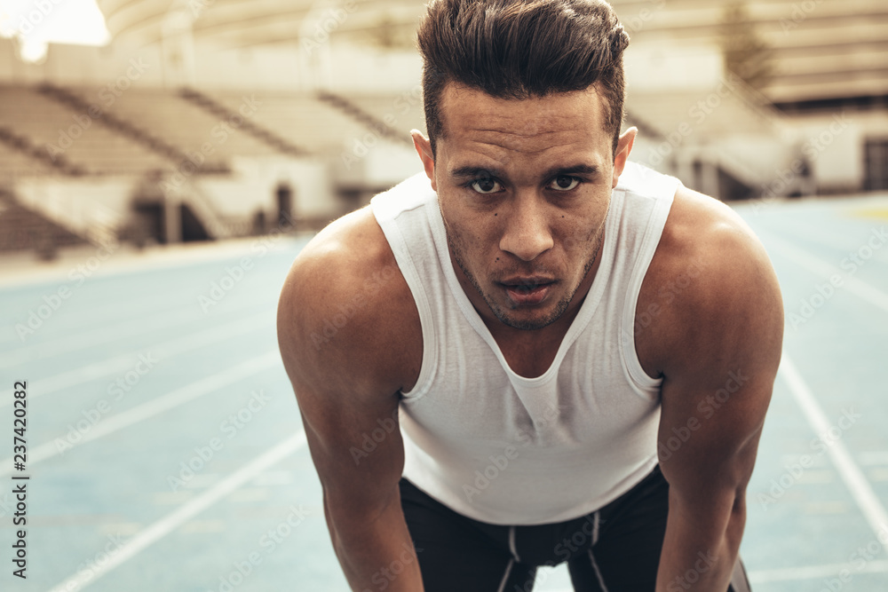 Sprinter standing on running track Sprinter standing on running track